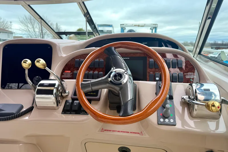  Yacht Photos Pics 2004 Searay 360 Sundancer helm with wooden steering wheel and control panel.