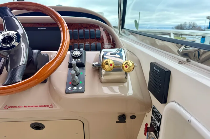  Yacht Photos Pics 2004 Searay 360 Sundancer helm with wooden steering wheel and control panel.