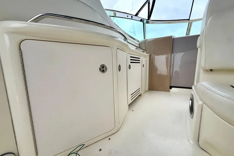  Yacht Photos Pics 2004 Searay 360 Sundancer interior with white cabinetry and seating, showcasing sleek design.