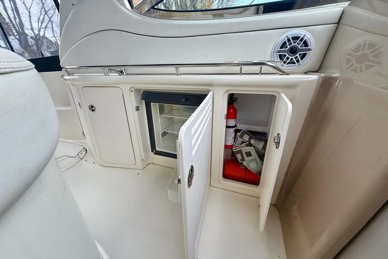  Yacht Photos Pics 2004 Searay 360 Sundancer interior with open cabinets, mini fridge, and fire extinguisher.
