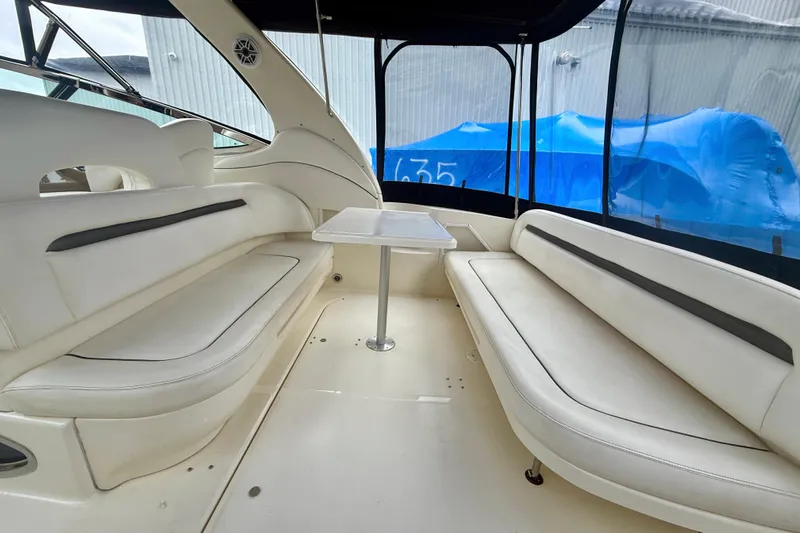  Yacht Photos Pics 2004 Searay 360 Sundancer interior with white seating and table, enclosed cockpit.
