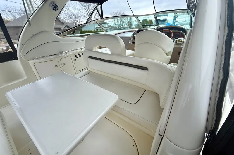  Yacht Photos Pics 2004 Searay 360 Sundancer interior with white seating and table, showcasing luxury design.