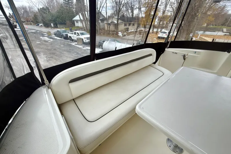  Yacht Photos Pics 2004 Searay 360 Sundancer interior with white seating and table, enclosed by clear panels.