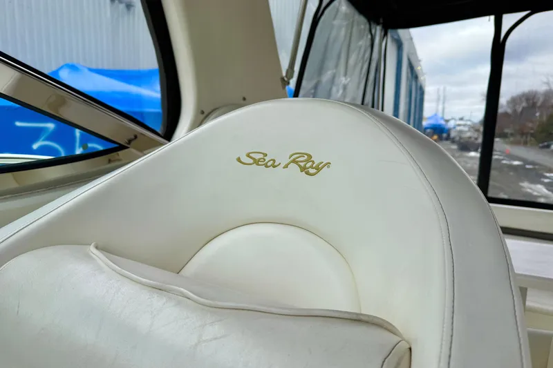  Yacht Photos Pics White leather seat with "Sea Ray" logo on a 2004 Searay 360 Sundancer boat.