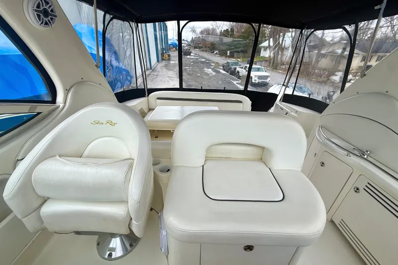  Yacht Photos Pics 2004 Searay 360 Sundancer boat interior with white seating and helm area.
