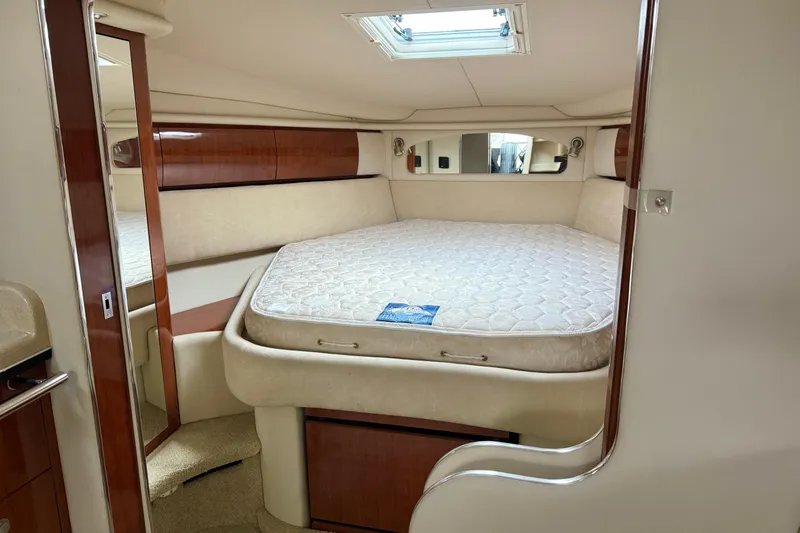  Yacht Photos Pics 2004 Searay 360 Sundancer cabin interior with bed, skylight, and wooden accents.