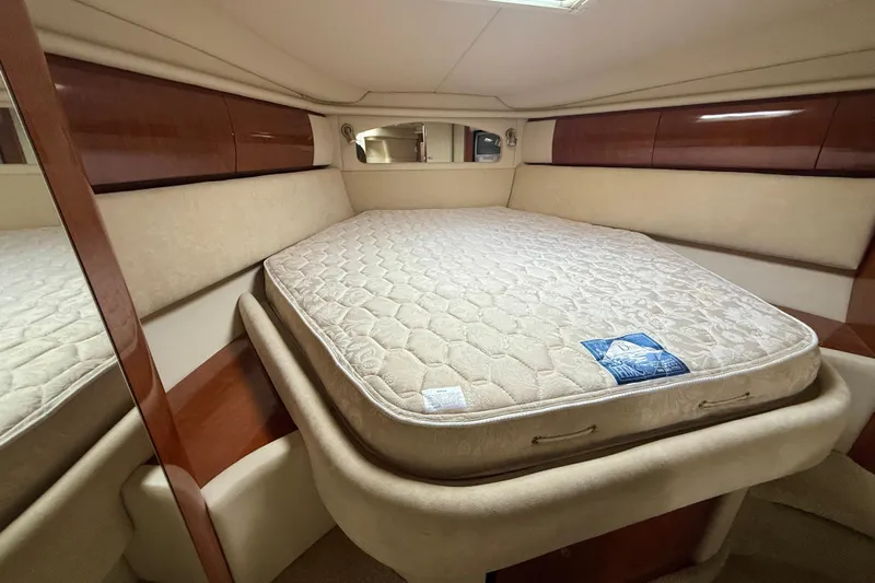  Yacht Photos Pics 2004 Searay 360 Sundancer cabin with a comfortable bed and elegant wood accents.