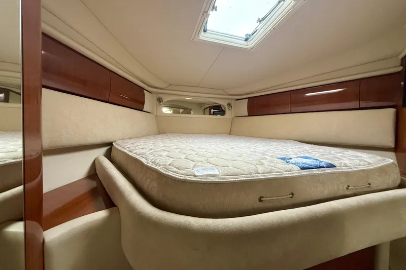  Yacht Photos Pics Interior cabin of 2004 Searay 360 Sundancer with bed and wooden accents.