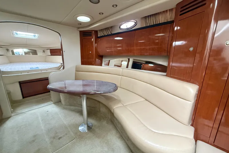  Yacht Photos Pics Interior of 2004 Searay 360 Sundancer yacht with beige seating and wooden cabinetry.