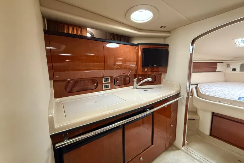  Yacht Photos Pics 2004 Searay 360 Sundancer yacht interior with sleek kitchen and cozy bedroom.