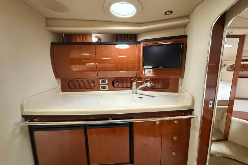  Yacht Photos Pics 2004 Searay 360 Sundancer yacht interior kitchen with wood cabinetry and modern appliances.