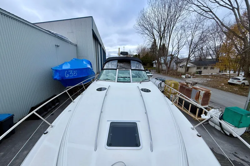  Yacht Photos Pics 2004 Searay 360 Sundancer yacht docked near storage buildings and trees.