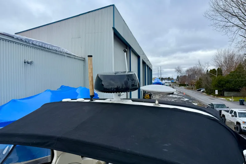  Yacht Photos Pics 2004 Searay 360 Sundancer boat with radar, docked near industrial buildings.