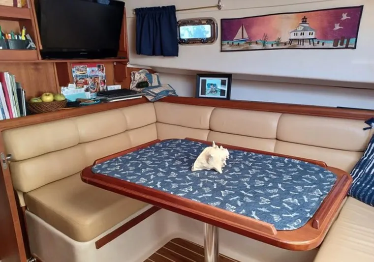 Arcadia Yacht Photos Pics 2005 Mainship 34 Pilot Rum Runner II interior with dining area and nautical decor.