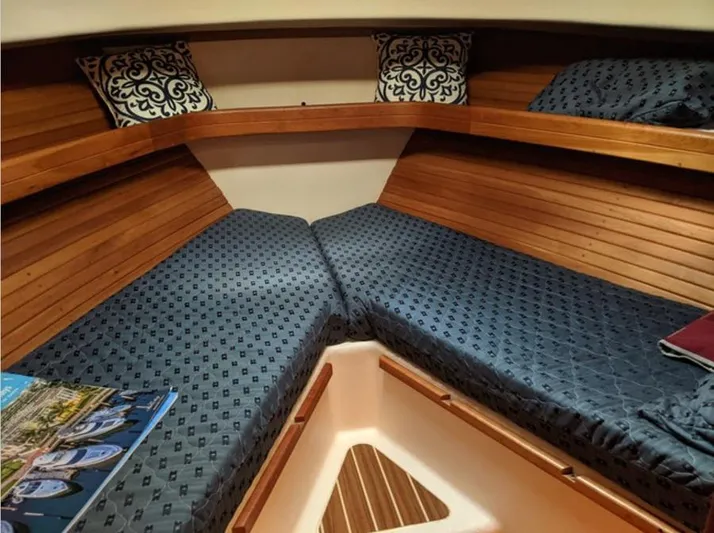 Arcadia Yacht Photos Pics 2005 Mainship 34 Pilot Rum Runner II cabin with blue bedding and decorative pillows.