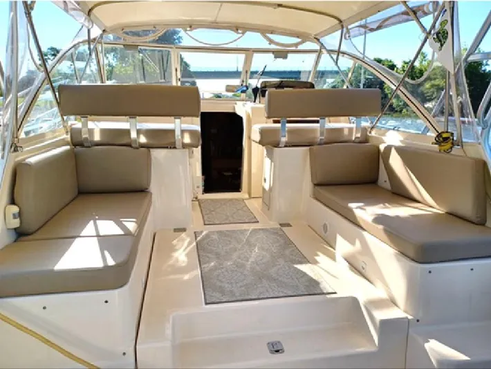 Arcadia Yacht Photos Pics 2005 Mainship 34 Pilot Rum Runner II interior with beige seating and open cabin view.