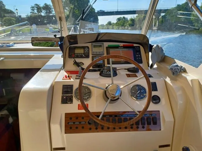 Arcadia Yacht Photos Pics 2005 Mainship 34 Pilot Rum Runner II helm with steering wheel and navigation instruments.
