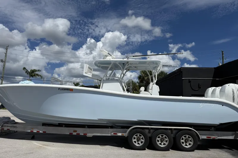  Yacht Photos Pics 2021 Yellowfin 36 Offshore boat on trailer under a partly cloudy sky.