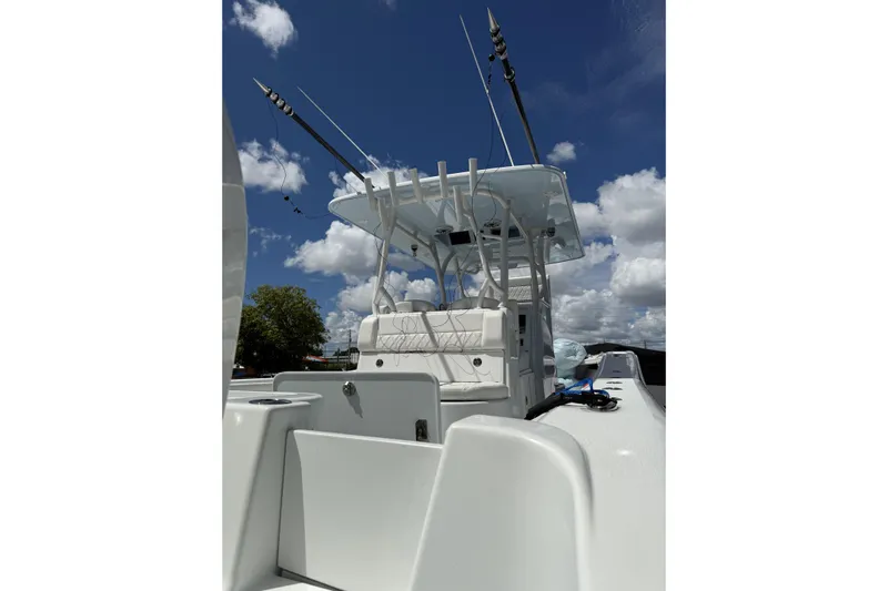  Yacht Photos Pics 2021 Yellowfin 36 Offshore boat with fishing rods under a clear blue sky.