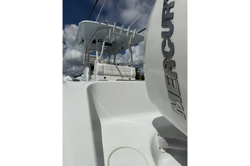  Yacht Photos Pics 2021 Yellowfin 36 Offshore boat with Mercury engine, under a cloudy sky.