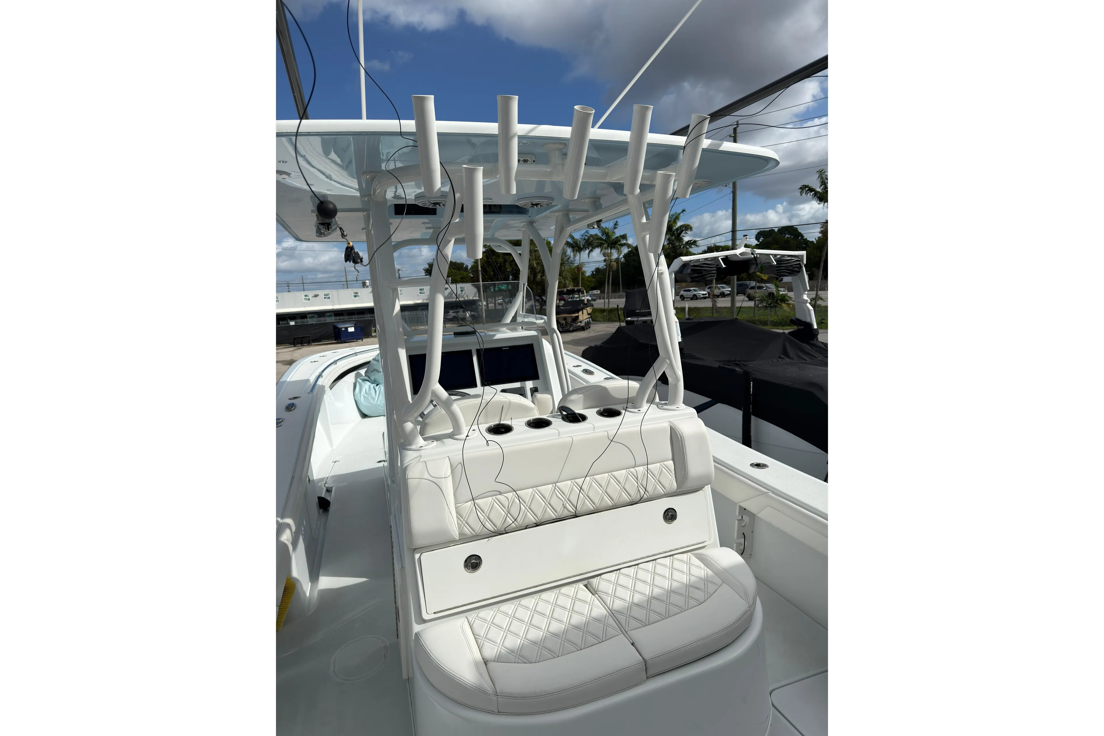  Yacht Photos Pics 2021 Yellowfin 36 Offshore boat with white seating and rod holders under a blue sky.