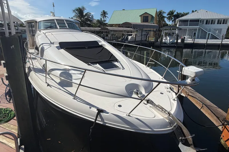  Yacht Photos Pics 2002 Sea Ray 480 Motor Yacht docked at marina, sunny day, palm trees in background.