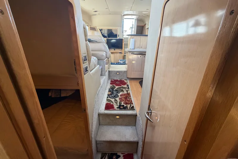  Yacht Photos Pics 2002 Sea Ray 480 Motor Yacht interior with carpeted stairs and cozy living area.