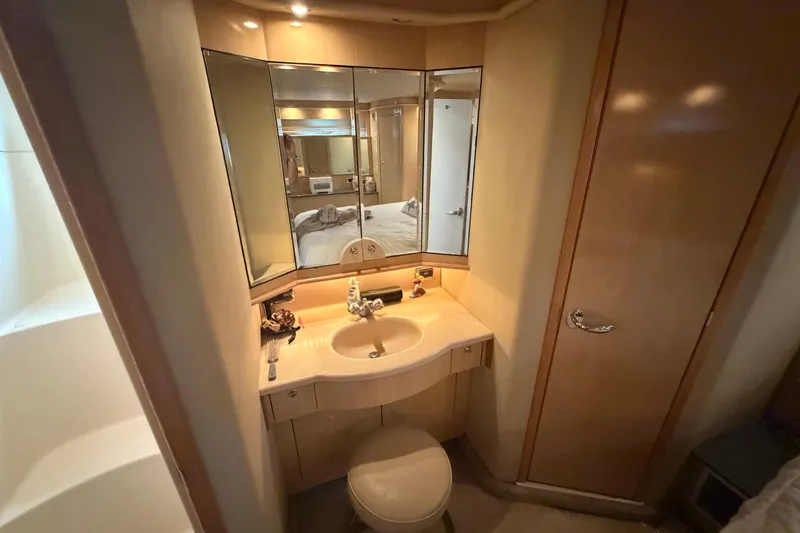  Yacht Photos Pics Bathroom interior of 2002 Sea Ray 480 Motor Yacht with mirrored vanity and sink.