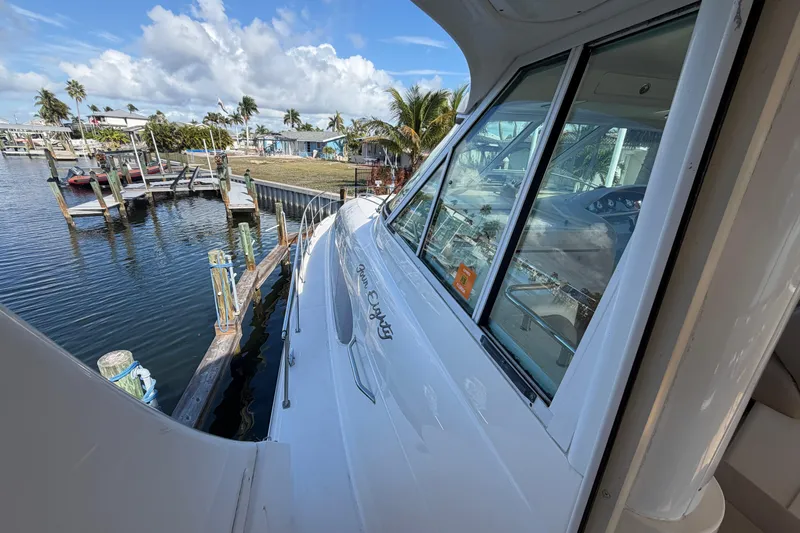  Yacht Photos Pics 2002 Sea Ray 480 Motor Yacht docked at marina, clear sky, palm trees in background.