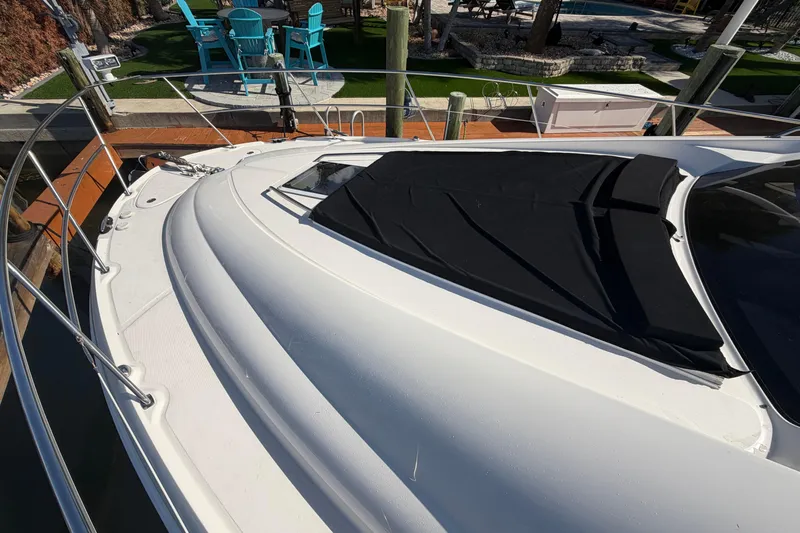  Yacht Photos Pics 2002 Sea Ray 480 Motor Yacht docked, featuring sleek white deck and black cover.