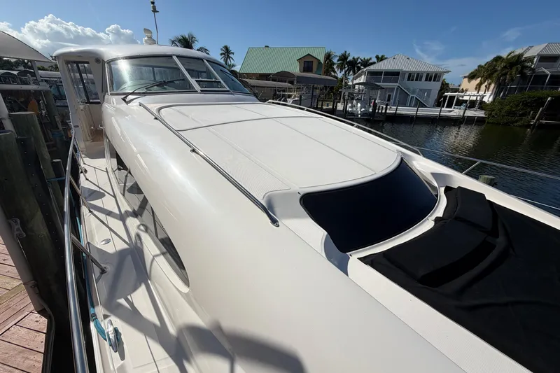 Yacht Photos Pics 2002 Sea Ray 480 Motor Yacht docked, showcasing sleek design and spacious deck.