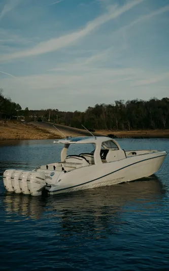  Yacht Photos Pics 2021 Deep Impact 399 Sport boat on a serene lake.