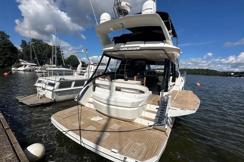 Yacht Photos Pics 2024 Galeon 500 Fly yacht docked at a marina under a clear blue sky.