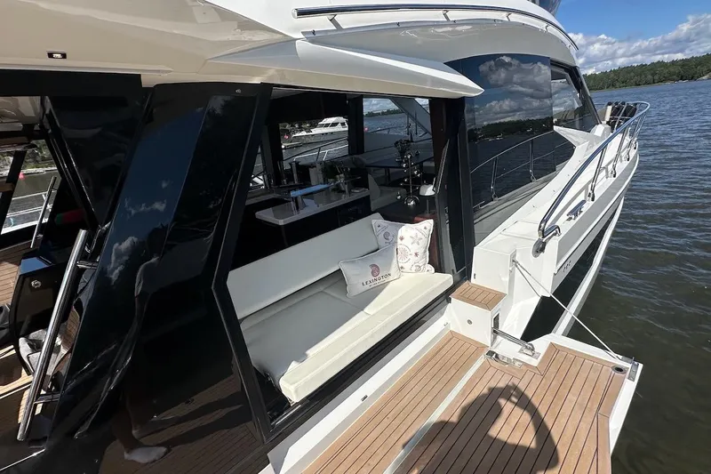  Yacht Photos Pics 2024 Galeon 500 Fly yacht with luxurious deck and seating area on the water.