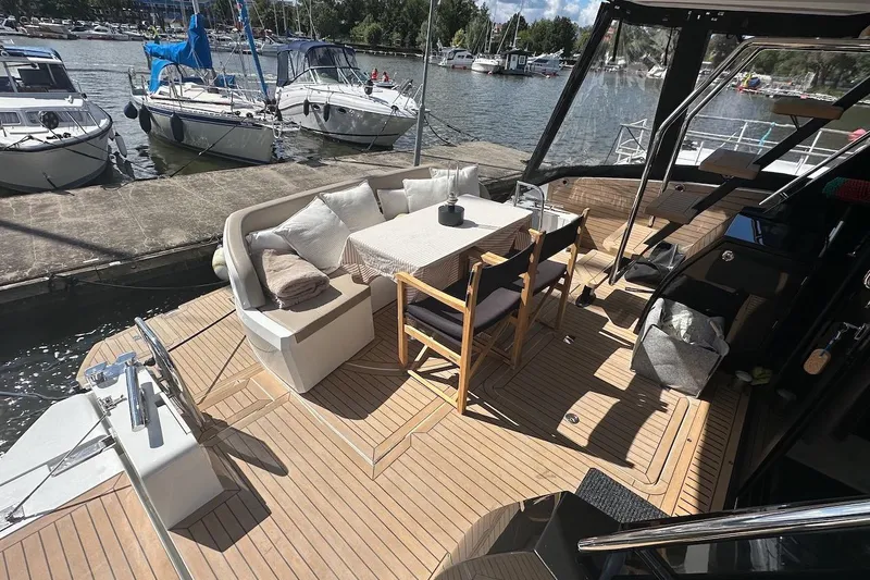  Yacht Photos Pics Luxurious 2024 Galeon 500 Fly yacht deck with seating and dining area at marina.