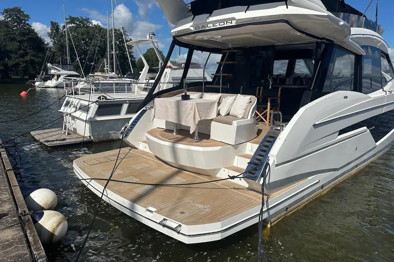  Yacht Photos Pics 2024 Galeon 500 Fly yacht docked, featuring elegant outdoor seating and sleek design.