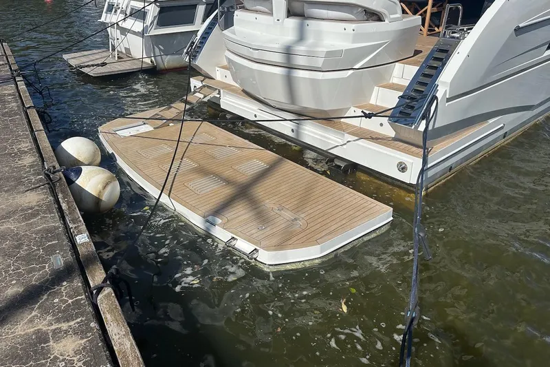  Yacht Photos Pics 2024 Galeon 500 Fly yacht with extended swim platform docked at marina.