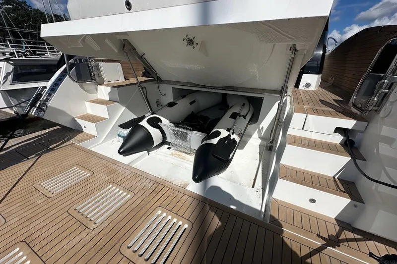  Yacht Photos Pics 2024 Galeon 500 Fly yacht with open storage compartment and inflatable watercraft.