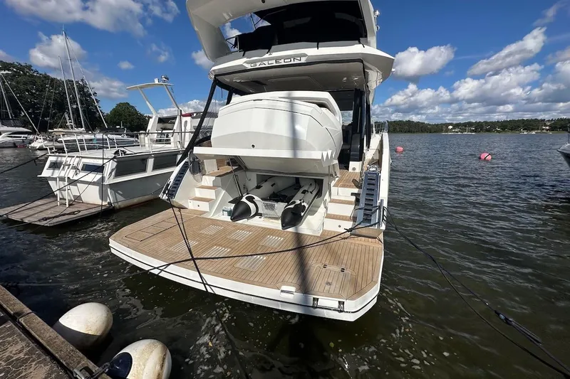  Yacht Photos Pics 2024 Galeon 500 Fly yacht docked at marina under blue sky.