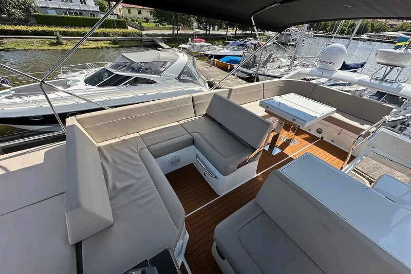  Yacht Photos Pics 2024 Galeon 500 Fly yacht with spacious seating and elegant design on a sunny day.