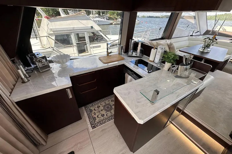  Yacht Photos Pics Luxurious interior of 2024 Galeon 500 Fly yacht with modern kitchen and dining area.