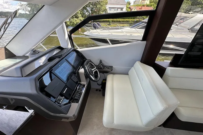  Yacht Photos Pics Interior of 2024 Galeon 500 Fly yacht with modern helm and white seating.