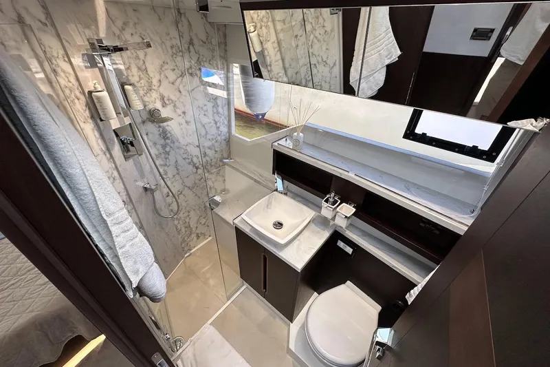  Yacht Photos Pics Luxurious bathroom in 2024 Galeon 500 Fly yacht with marble accents and modern fixtures.
