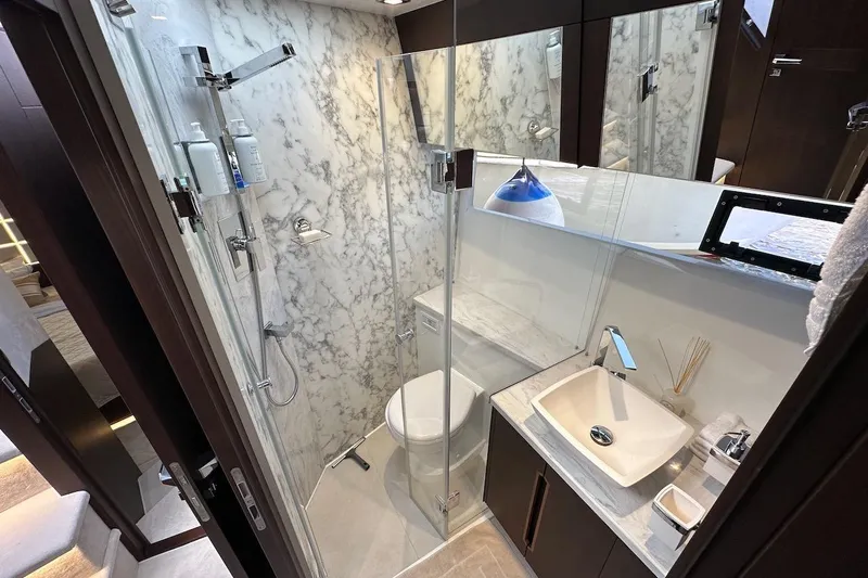  Yacht Photos Pics Luxurious bathroom in 2024 Galeon 500 Fly yacht with marble accents and modern fixtures.
