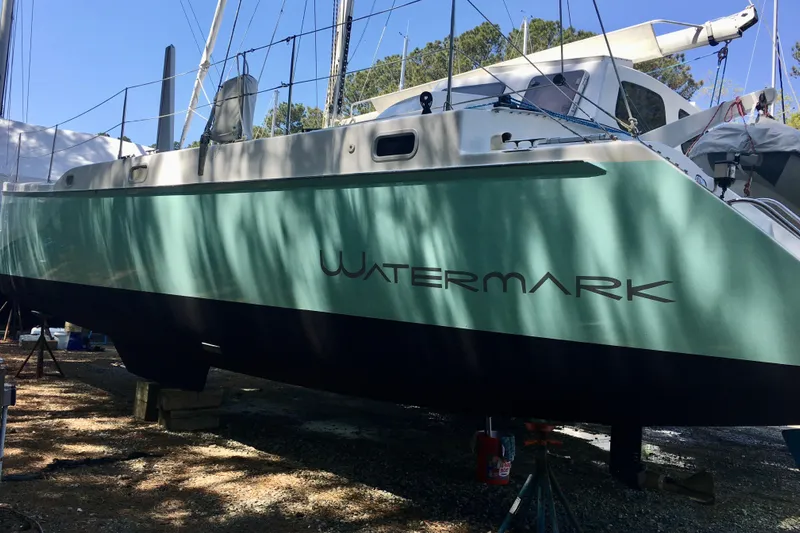 Watermark Yacht Photos Pics 2003 Chris White Atlantic 42 catamaran named "Watermark" on land, green hull, trees in background.