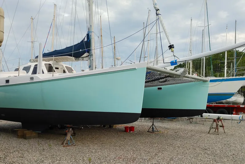 Watermark Yacht Photos Pics 2003 Chris White Atlantic 42 catamaran on dry dock, surrounded by other sailboats.