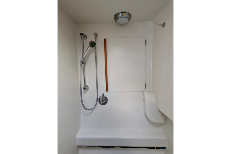 Watermark Yacht Photos Pics Shower area in 2003 Chris White Atlantic 42 yacht, featuring handheld showerhead and storage compartment.
