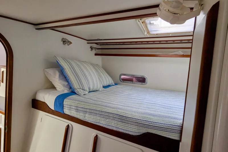 Watermark Yacht Photos Pics Cozy cabin interior of 2003 Chris White Atlantic 42 yacht with striped bedding.