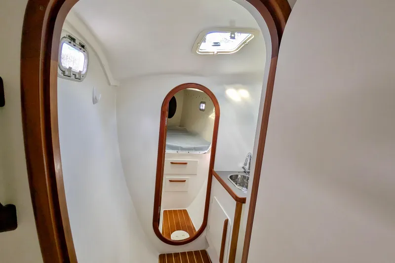 Watermark Yacht Photos Pics Interior of 2003 Chris White Atlantic 42 yacht, featuring a compact cabin with wood accents.