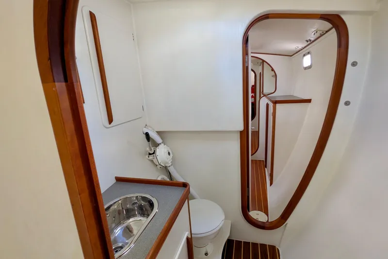 Watermark Yacht Photos Pics Interior of 2003 Chris White Atlantic 42 yacht, featuring a compact bathroom with wooden accents.